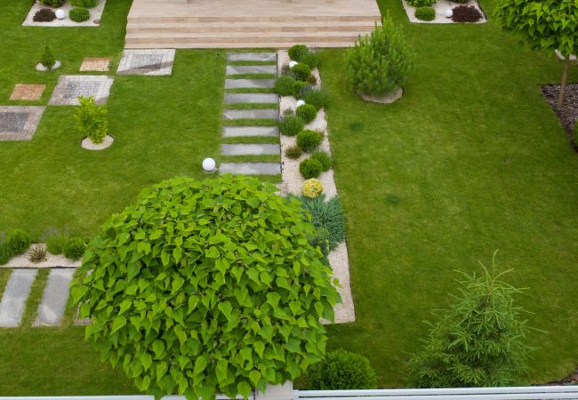 Garden with walkways and green grass. Photo taken from above drone. Garden with walkways and green grass. Photo taken from above drone.